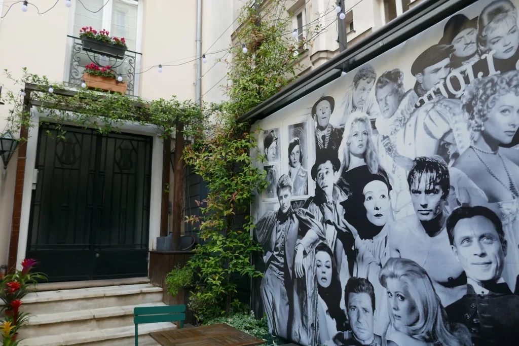 Studio 28 cinema/courtyard area with a mural showing many French film stars. Image by Courtney Traub/All rights reserved