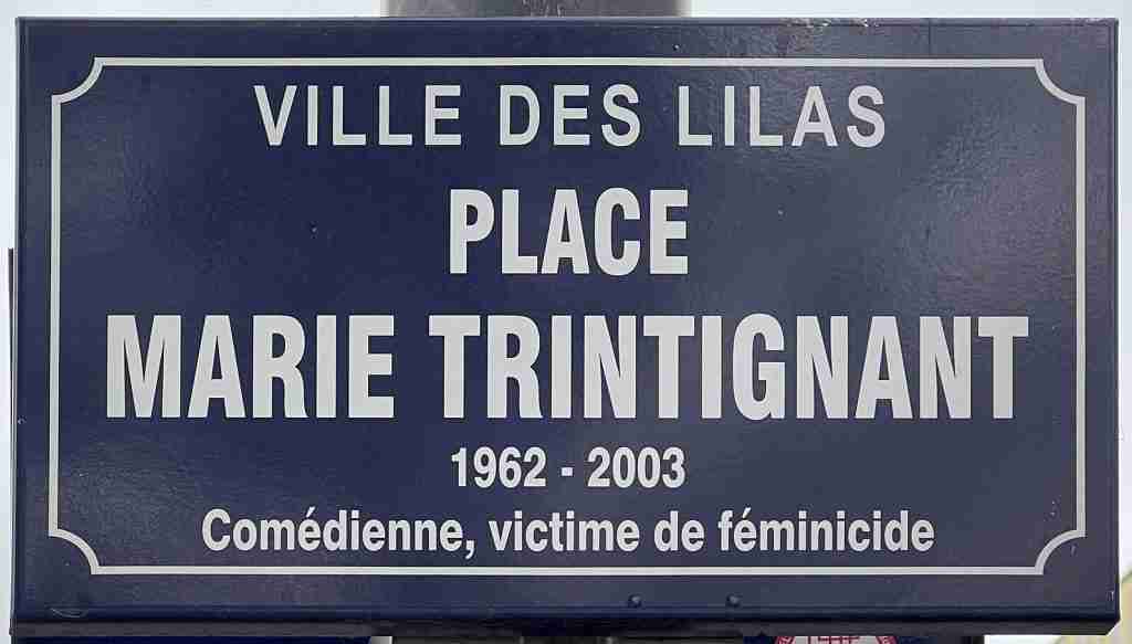 Plaque dedicated to French actress Marie Trintignant in Les Lilas, France. It reads "Ville des Lilas - Place Marie Trintingnant - 1962-2003 - Comédienne, victime de féminicide" (Actress and victim of femicide)